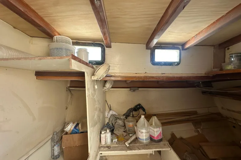Slide: The Image of Interior of 1994 Pilot Schooner Leopard, showing storage area with supplies and wooden beams. - 66