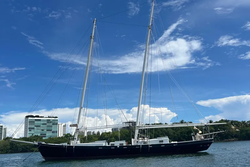 Slide: The Image of Schooner Leopard 1994 sailing near urban skyline under clear blue sky. - 7