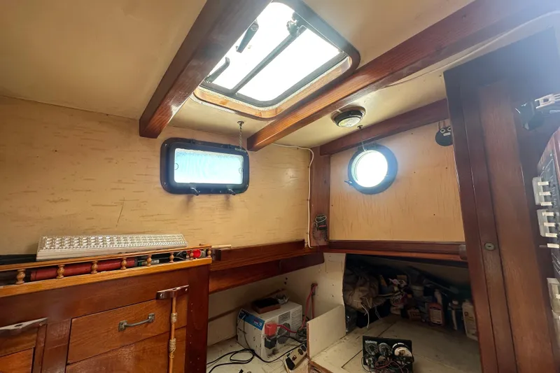 Slide: The Image of Interior of 1994 Pilot Schooner Leopard with wooden cabinetry and porthole windows. - 72