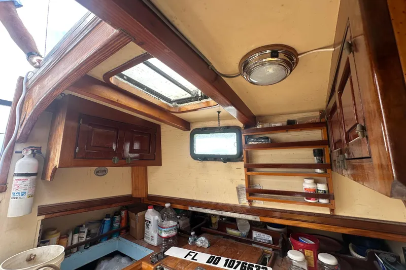 Slide: The Image of Interior of 1994 Pilot Schooner Leopard with wooden cabinets and nautical equipment. - 74