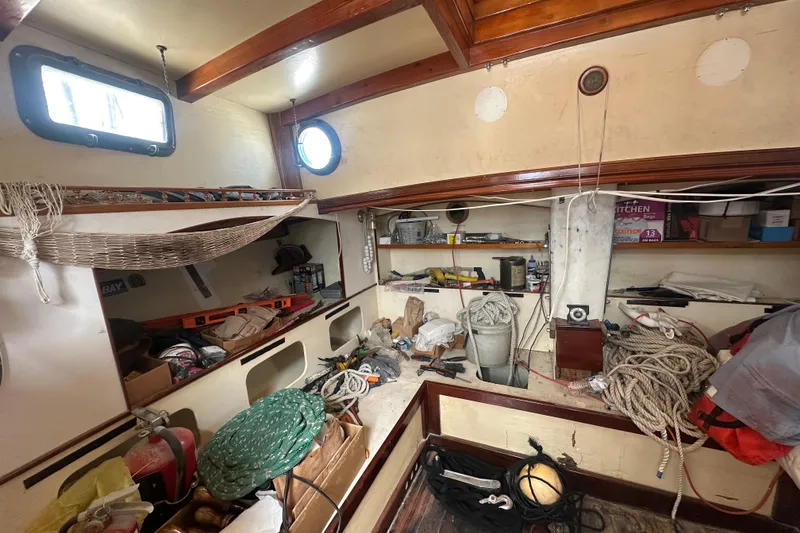 Slide: The Image of Interior of 1994 Pilot Schooner Leopard, showcasing storage and nautical equipment. - 76