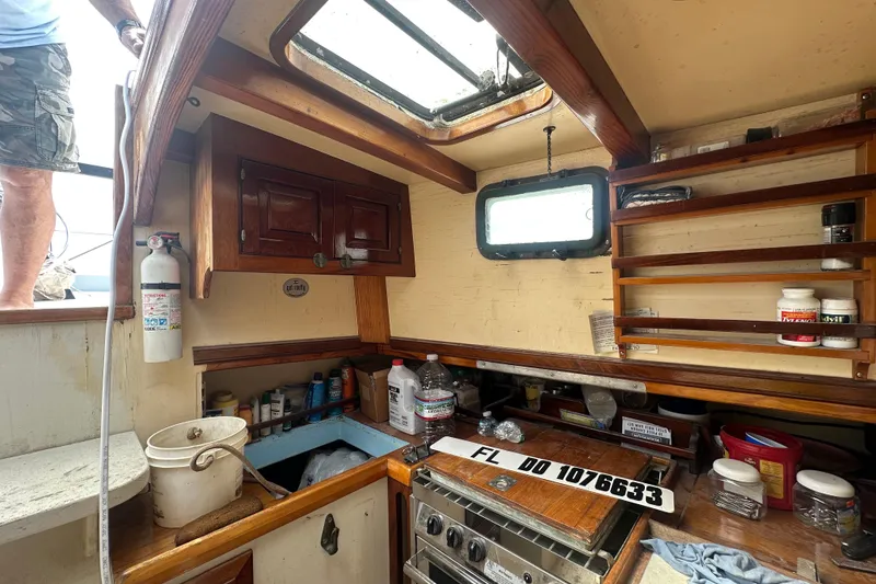 Slide: The Image of Cozy 1994 Pilot Schooner Leopard kitchen with wooden cabinets and nautical decor. - 77
