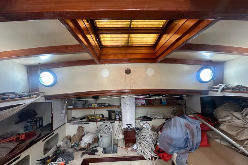 Slide: The Image of Interior of 1994 Pilot Schooner Leopard with wooden beams, portholes, and nautical equipment. - 78