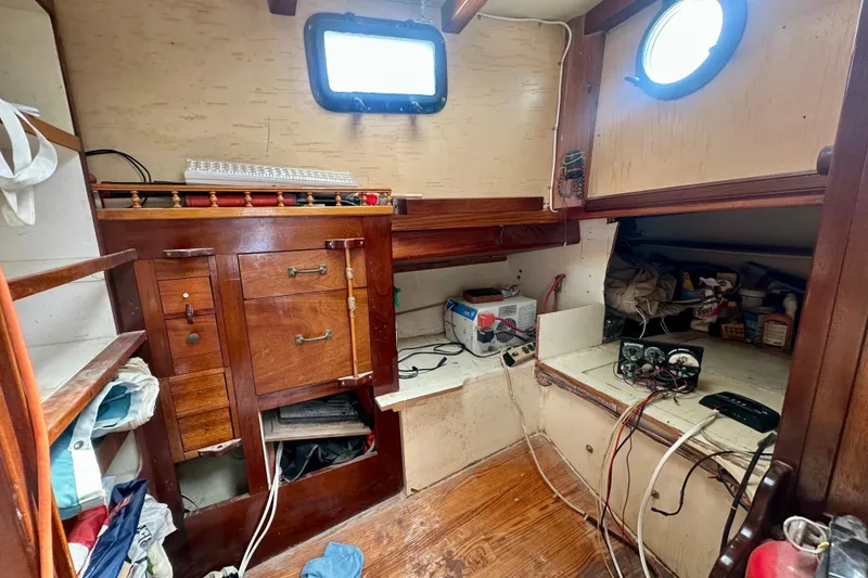 Slide: The Image of Interior of 1994 Pilot Schooner Leopard with wooden cabinetry and nautical equipment. - 79
