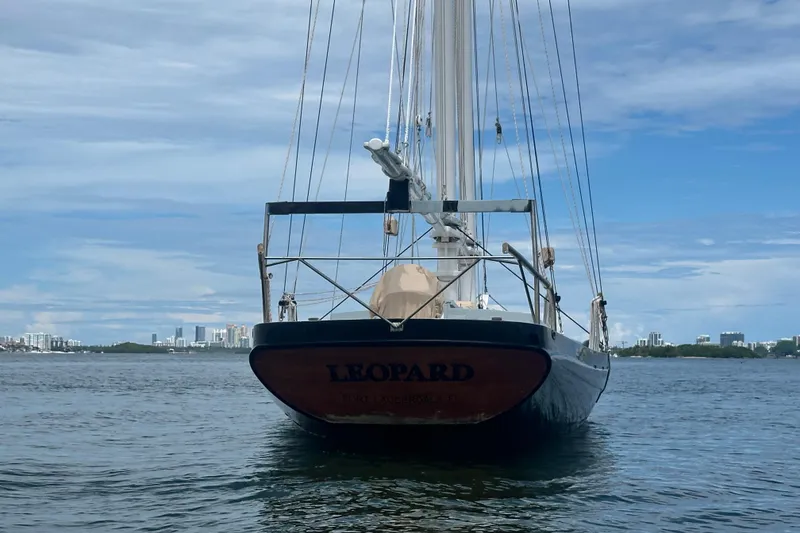 Slide: The Image of Schooner Leopard sailboat on calm water, city skyline in background, 1994 model. - 8