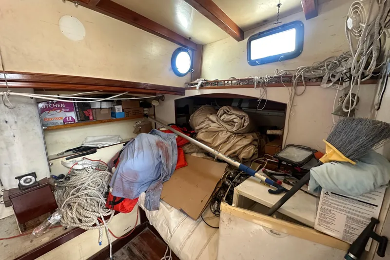 Slide: The Image of Cluttered interior of 1994 Pilot Schooner Leopard with ropes, boxes, and cleaning tools. - 80