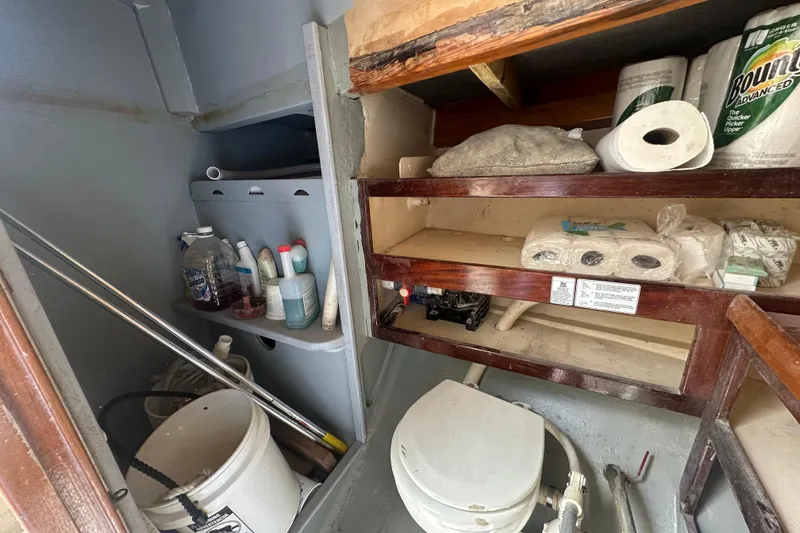 Slide: The Image of Storage area on 1994 Pilot Schooner Leopard with cleaning supplies and paper products. - 82