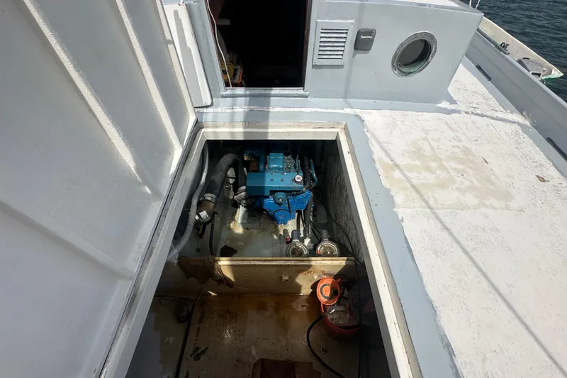 Slide: The Image of Engine compartment of 1994 Pilot Schooner Leopard, showcasing blue machinery and surrounding components. - 89