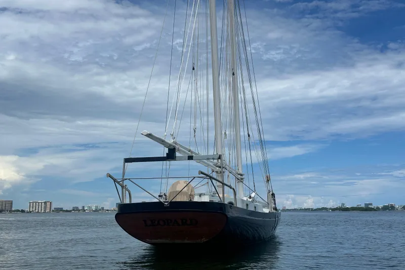 Slide: The Image of Schooner Leopard sailboat on calm water under a partly cloudy sky, 1994 model. - 9