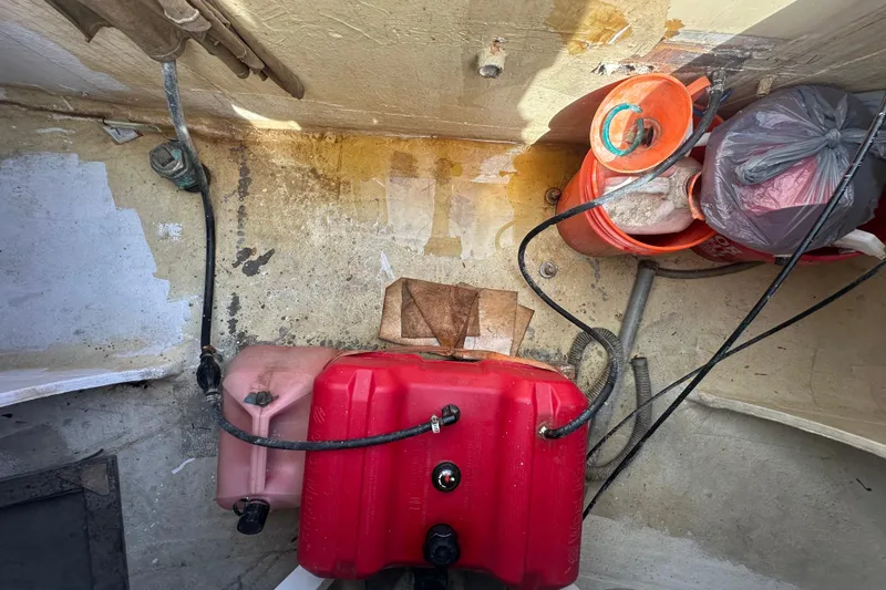 Slide: The Image of Bilge area of 1994 Pilot Schooner Leopard with fuel tank and storage items. - 90