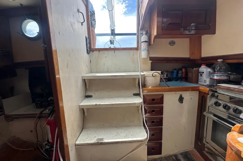 Slide: The Image of Interior of 1994 Pilot Schooner Leopard with stairs, kitchen, and storage. - 93