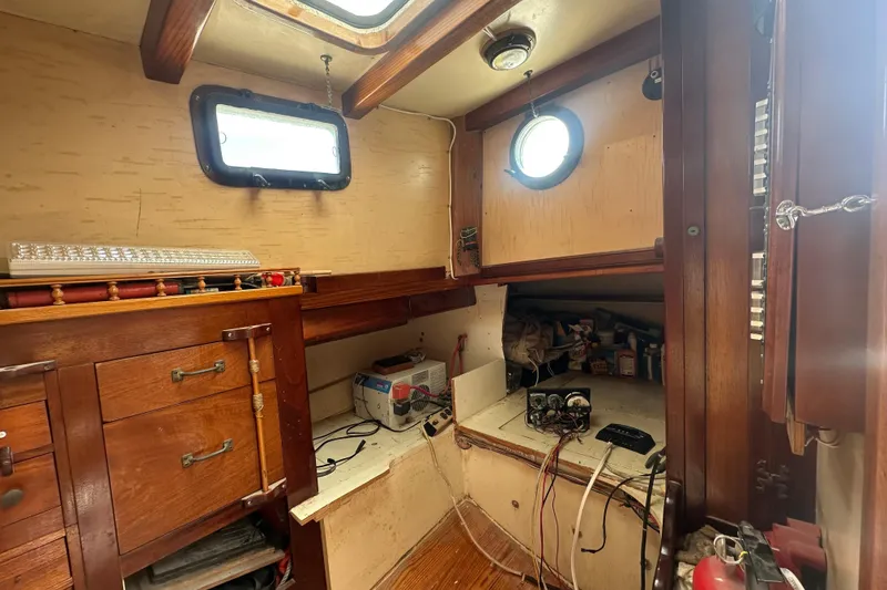 Slide: The Image of Interior of 1994 Pilot Schooner Leopard with wooden cabinetry and nautical equipment. - 94
