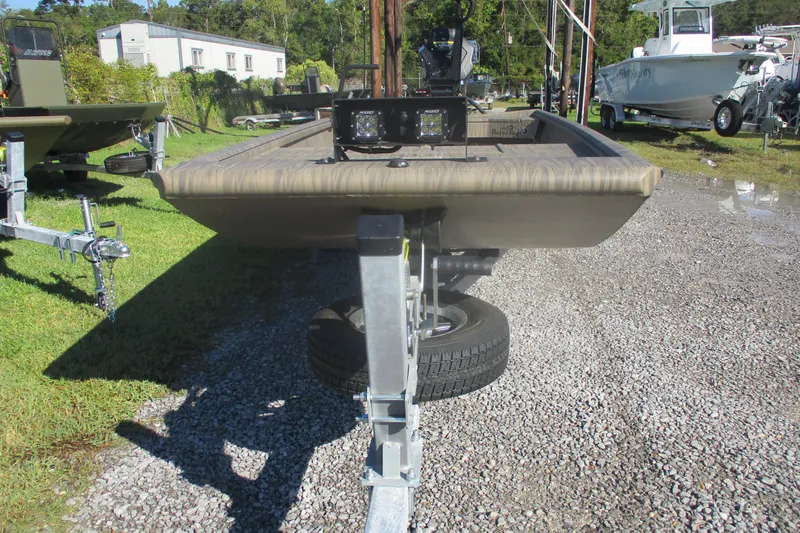 Slide: The Image of 2026 Gator Tail 1754 Extreme boat on trailer, parked outdoors on gravel. - 2