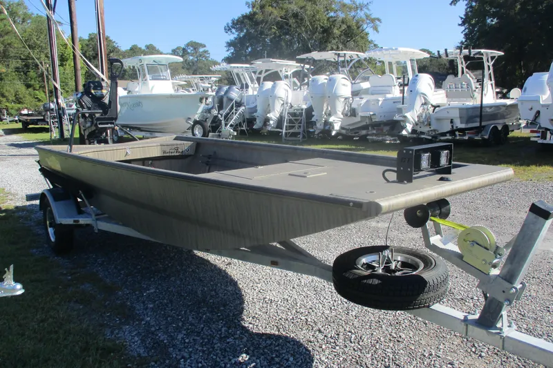 Slide: The Image of 2026 Gator Tail 1754 Extreme boat on trailer, surrounded by other boats in a lot. - 3