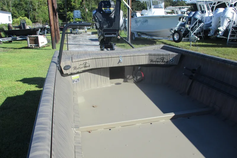 Slide: The Image of 2026 Gator Tail 1754 Extreme boat, interior view, parked on grass with other boats nearby. - 6