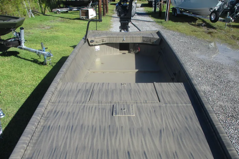 Slide: The Image of 2026 Gator Tail 1754 Extreme boat, camo design, parked on grass near trailers. - 7