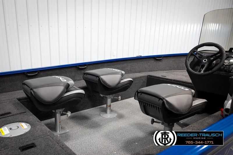 Slide: The Image of 2025 Lund Rebel XL SS boat interior with three black seats and steering wheel. - 12