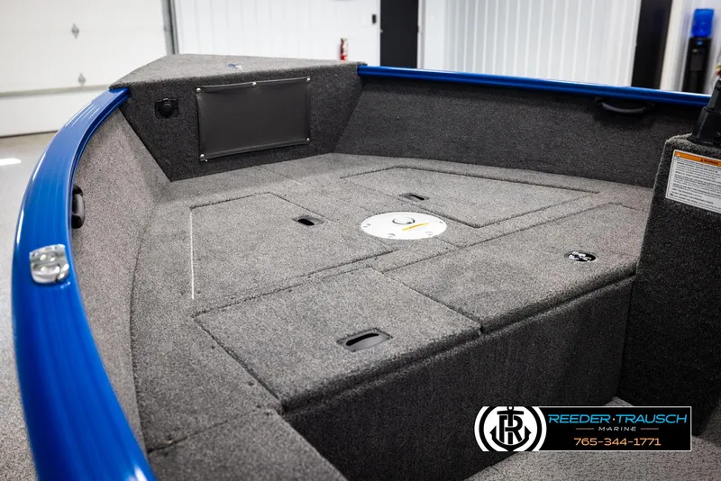 Slide: The Image of 2025 Lund Rebel XL SS boat interior with gray carpet and blue trim. - 15