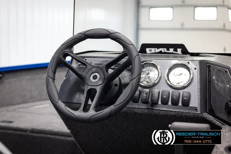 Slide: The Image of 2025 Lund Rebel XL SS boat dashboard with steering wheel and gauges. - 18