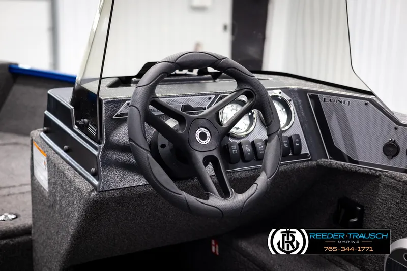 Slide: The Image of 2025 Lund Rebel XL SS boat dashboard with steering wheel and gauges. - 19