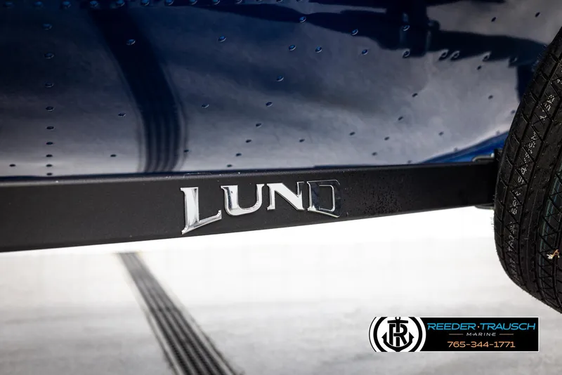 Slide: The Image of 2025 Lund Rebel XL SS boat trailer with logo and tire detail. - 37
