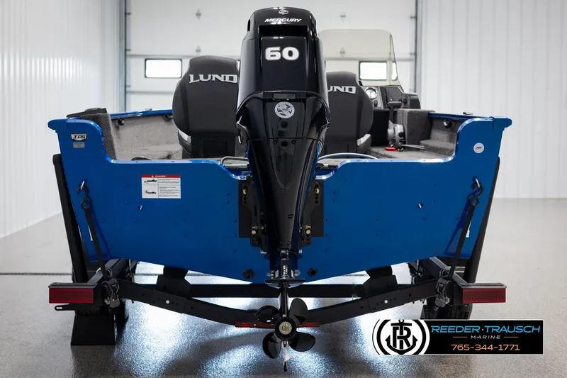 Slide: The Image of 2025 Lund Rebel XL SS boat with Mercury 60 engine, displayed indoors. - 5