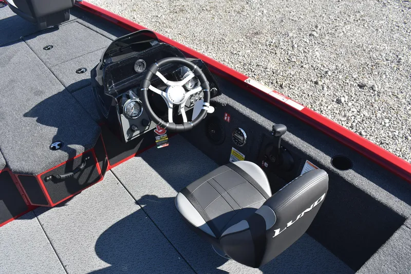 Slide: The Image of 2026 Lund 1875 Renegade boat interior with steering wheel and seat. - 12