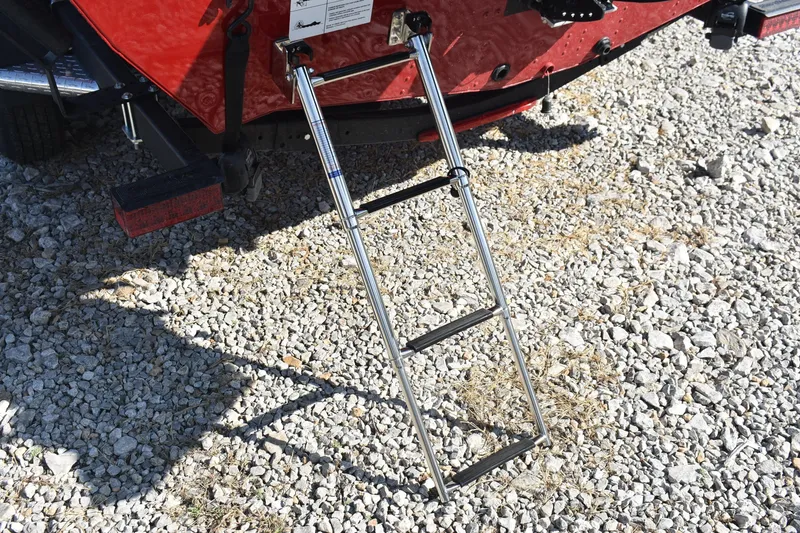 Slide: The Image of 2026 Lund 1875 Renegade boat ladder on gravel surface. - 16