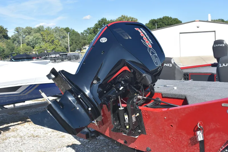 Slide: The Image of 2026 Lund 1875 Renegade boat with powerful outboard motor, parked outdoors. - 6