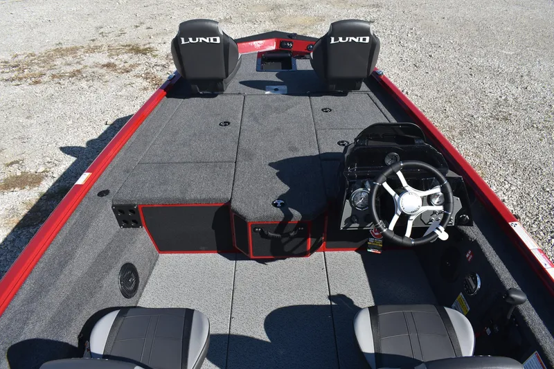 Slide: The Image of 2026 Lund 1875 Renegade boat interior with steering wheel and seating. - 9