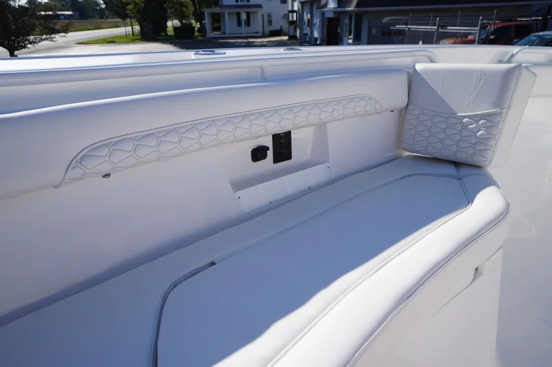 Slide: The Image of 2026 Tidewater 272 LXF boat interior with white cushioned seating and geometric design. - 11