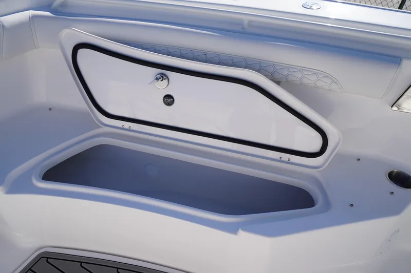 Slide: The Image of 2026 Tidewater 272 LXF boat storage compartment with secure latch and sleek design. - 16