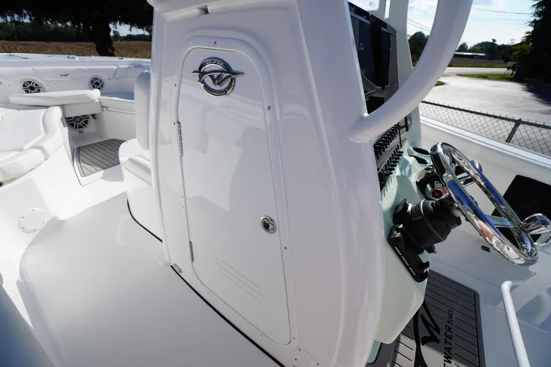 Slide: The Image of 2026 Tidewater 272 LXF boat interior with steering wheel and seating area. - 25