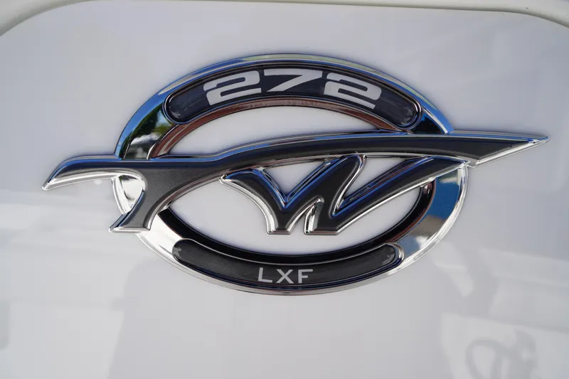 Slide: The Image of Chrome emblem of 2026 Tidewater 272 LXF boat model on white background. - 3