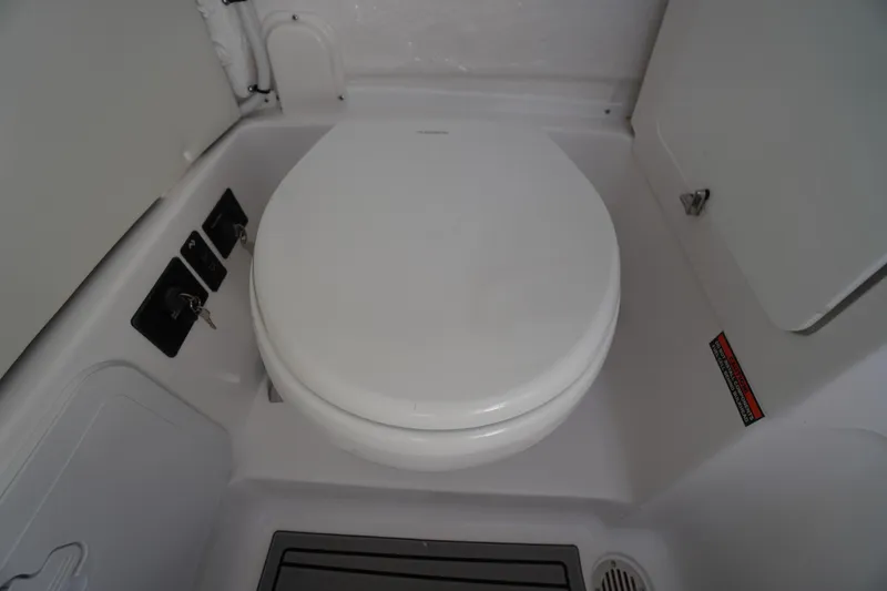 Slide: The Image of 2026 Tidewater 272 LXF boat interior with a compact marine toilet. - 30