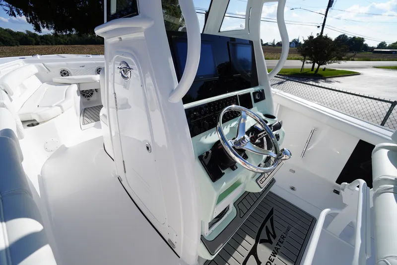 Slide: The Image of 2026 Tidewater 272 LXF boat cockpit with modern steering and navigation controls. - 32