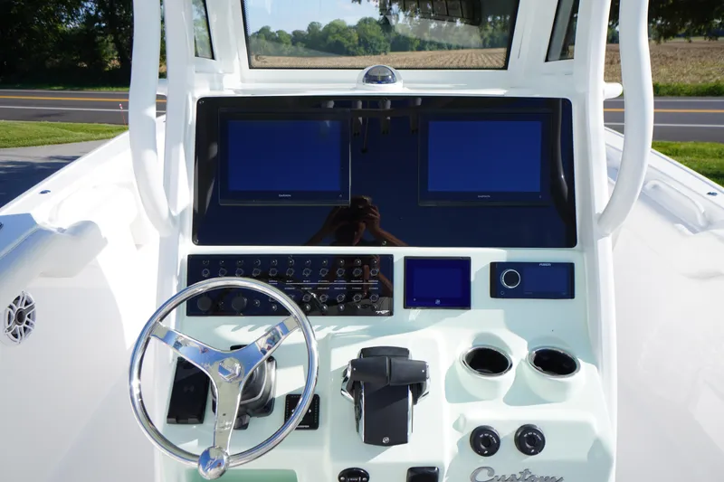 Slide: The Image of 2026 Tidewater 272 LXF boat dashboard with dual screens and steering wheel. - 33