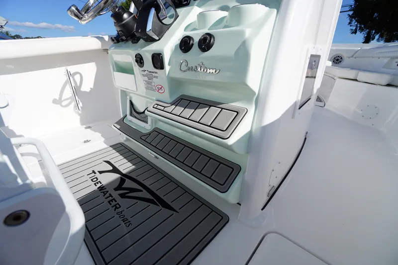 Slide: The Image of 2026 Tidewater 272 LXF boat interior with custom console and branded flooring. - 34