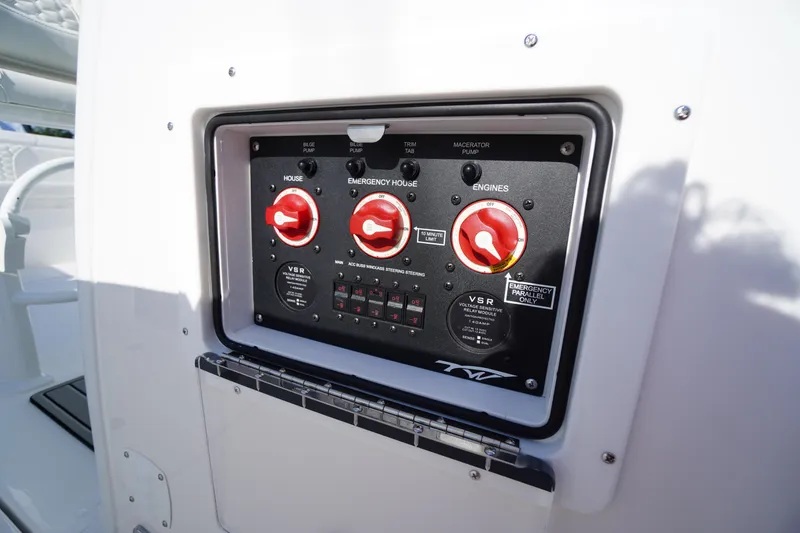 Slide: The Image of Control panel of 2026 Tidewater 272 LXF boat with red switches and labels. - 42
