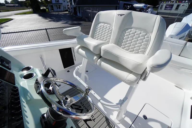 Slide: The Image of 2026 Tidewater 272 LXF boat interior with luxurious white seating and modern steering console. - 46