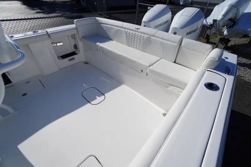 Slide: The Image of 2026 Tidewater 272 LXF boat interior with white seating and dual Mercury engines. - 49