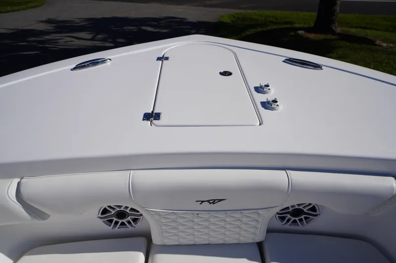 Slide: The Image of Bow view of 2026 Tidewater 272 LXF boat with sleek white design and speakers. - 5