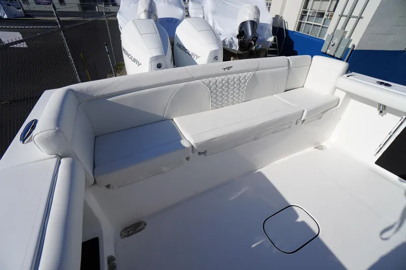 Slide: The Image of 2026 Tidewater 272 LXF boat with white seating and dual Mercury engines. - 51