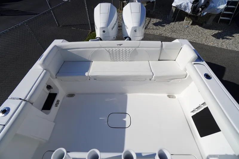 Slide: The Image of 2026 Tidewater 272 LXF boat interior with white seating and dual engines. - 52
