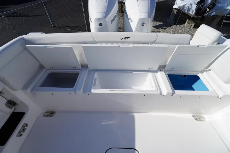 Slide: The Image of 2026 Tidewater 272 LXF boat with open storage compartments and dual Mercury engines. - 53