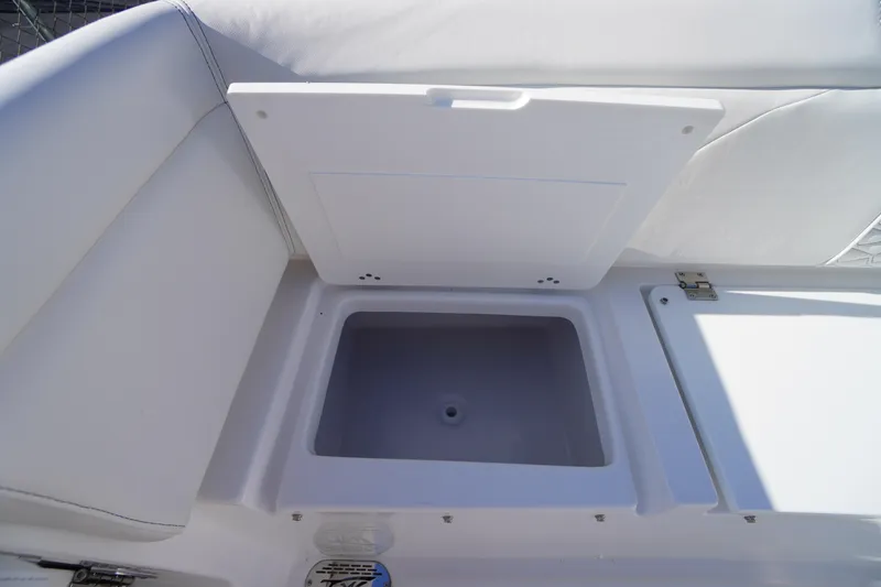 Slide: The Image of 2026 Tidewater 272 LXF boat storage compartment with open lid, showcasing interior space. - 54