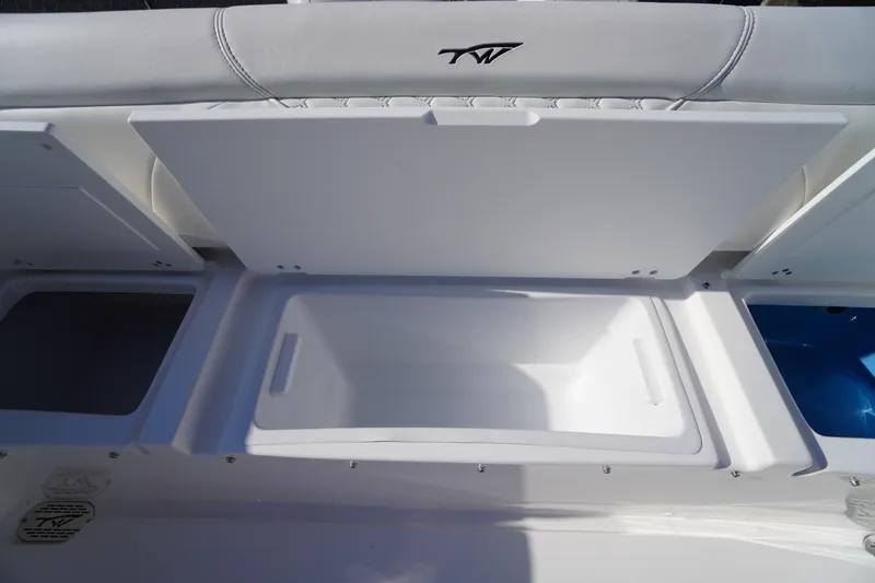 Slide: The Image of 2026 Tidewater 272 LXF boat storage compartments with open lids, showcasing interior space. - 55