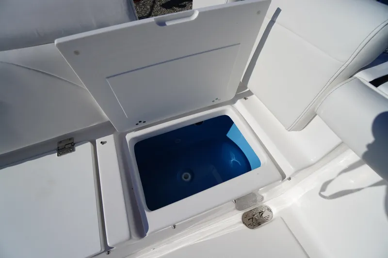 Slide: The Image of 2026 Tidewater 272 LXF boat storage compartment with open lid, showcasing interior space. - 57