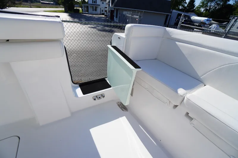 Slide: The Image of 2026 Tidewater 272 LXF boat interior with white seating and open side door. - 59