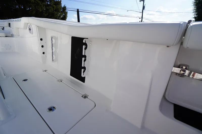 Slide: The Image of 2026 Tidewater 272 LXF boat interior, featuring sleek white design and storage compartments. - 61